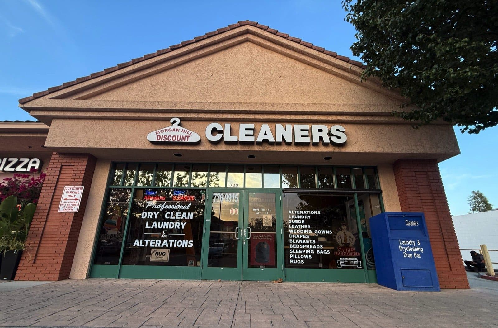 Morgan Hill Discount Cleaners storefront on Monterey Road, with the blue Go Express 24-hour drop box out front